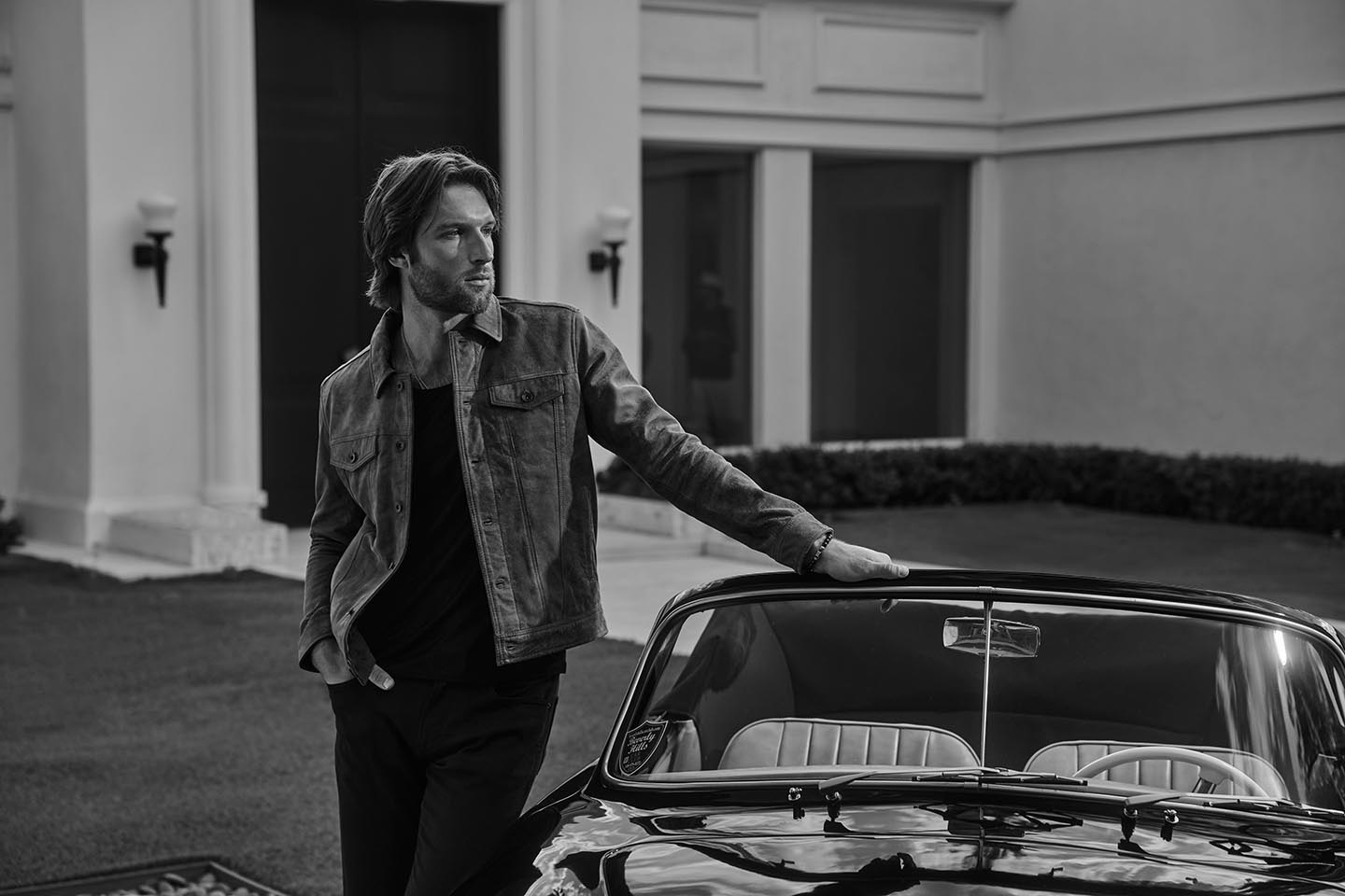 handsome bearded man with sports car