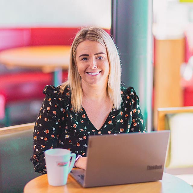 Young blonde woman working on a laptop