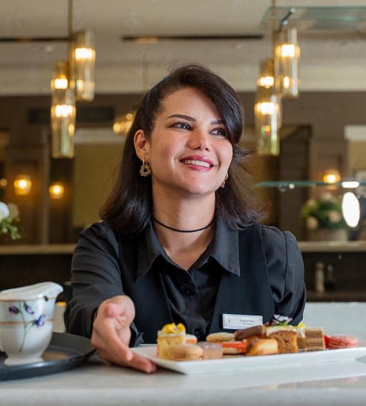 woman serving tea and biscuits