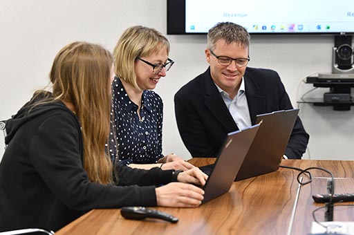 people sharing a laptop