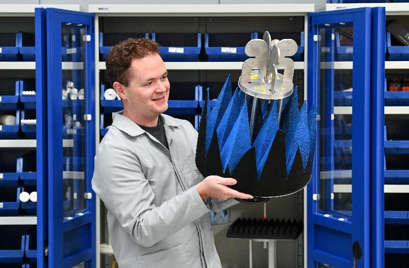 A man holding a blue and silver piece of equipment
