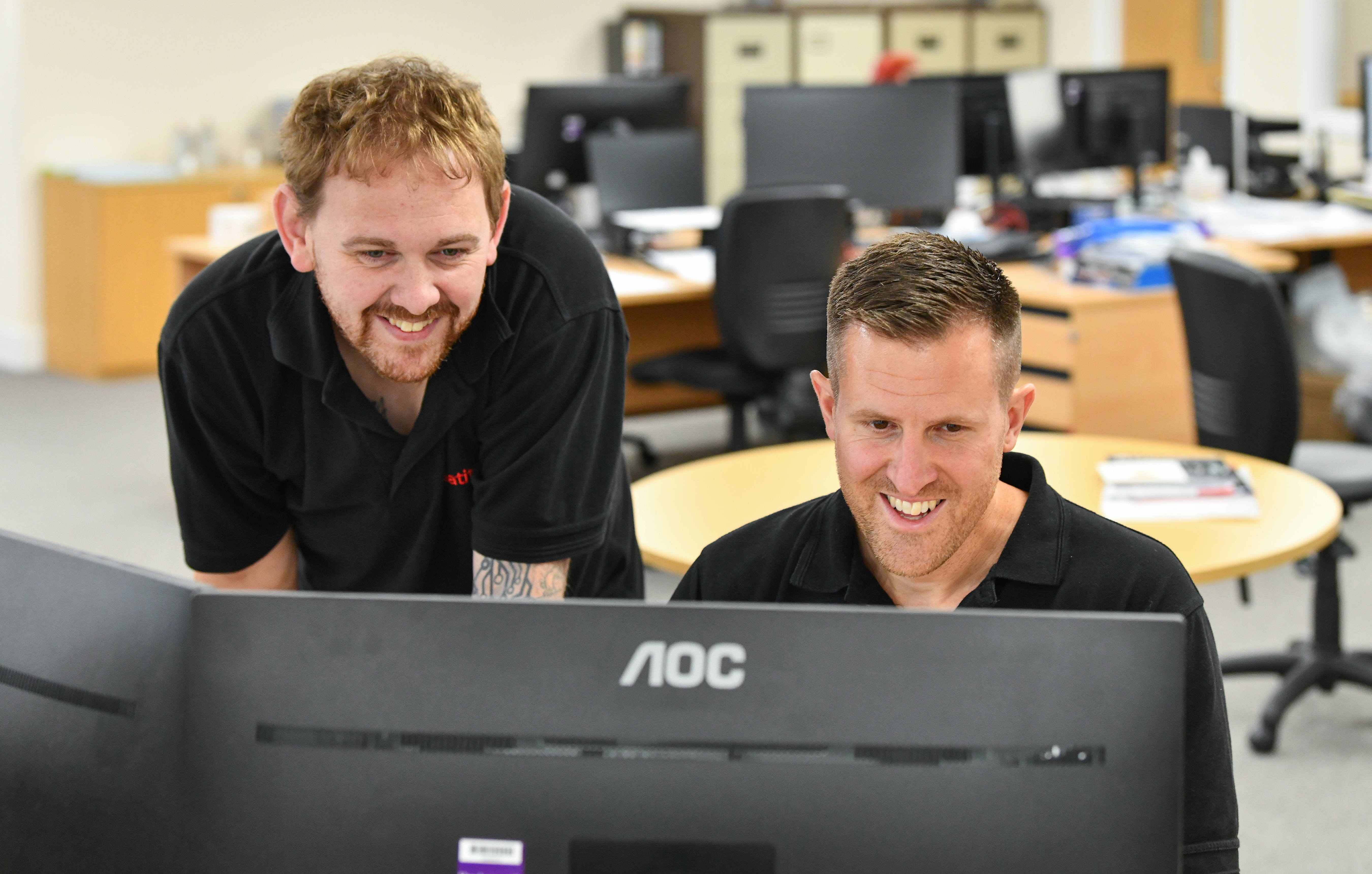 Coworkers consulting a spreadsheet