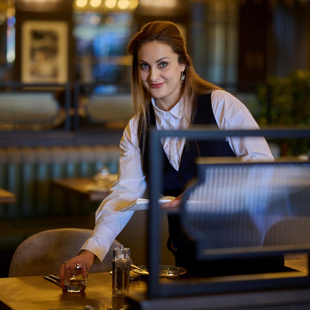 waitress arranging a place setting
