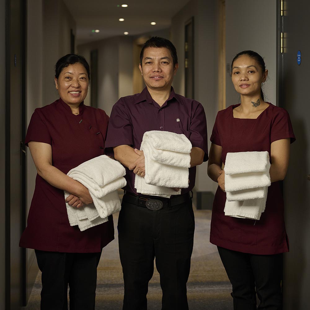 a group of housekeepers carrying towels