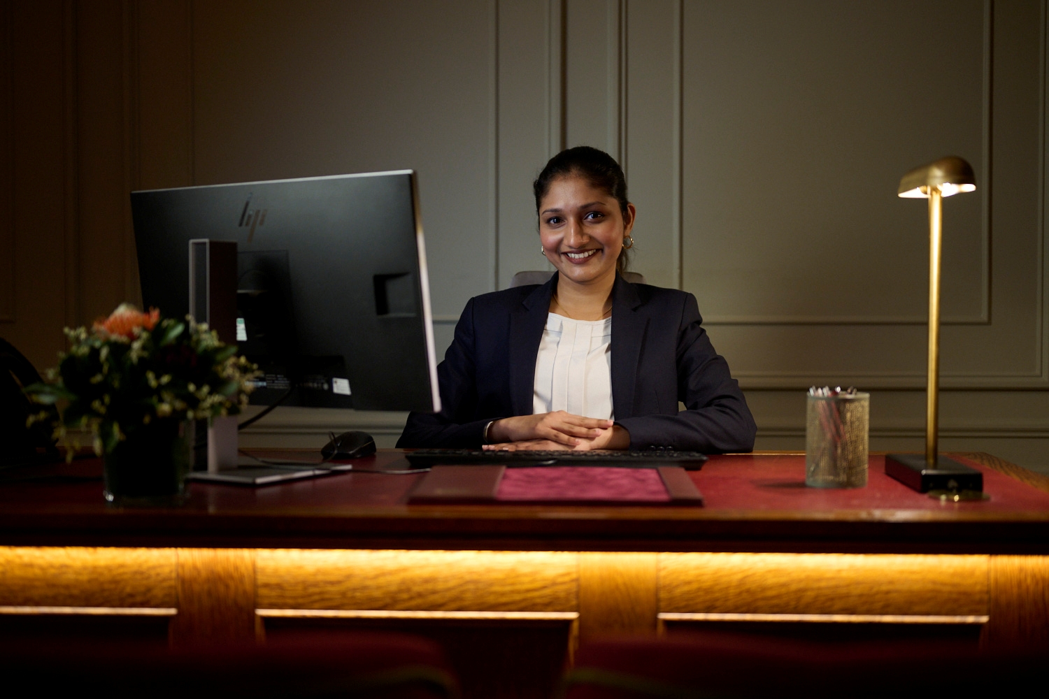 receptionist at front desk smiling