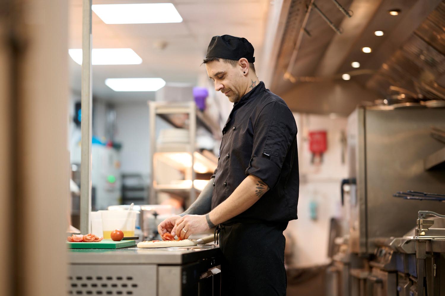 chef with tattoos prepares ingredients