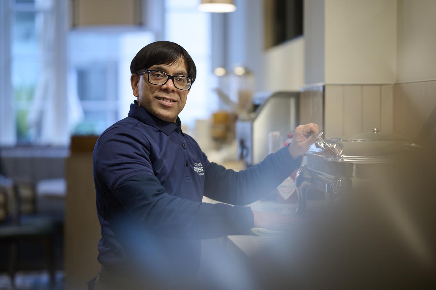 waiter preparing to serve breakfast
